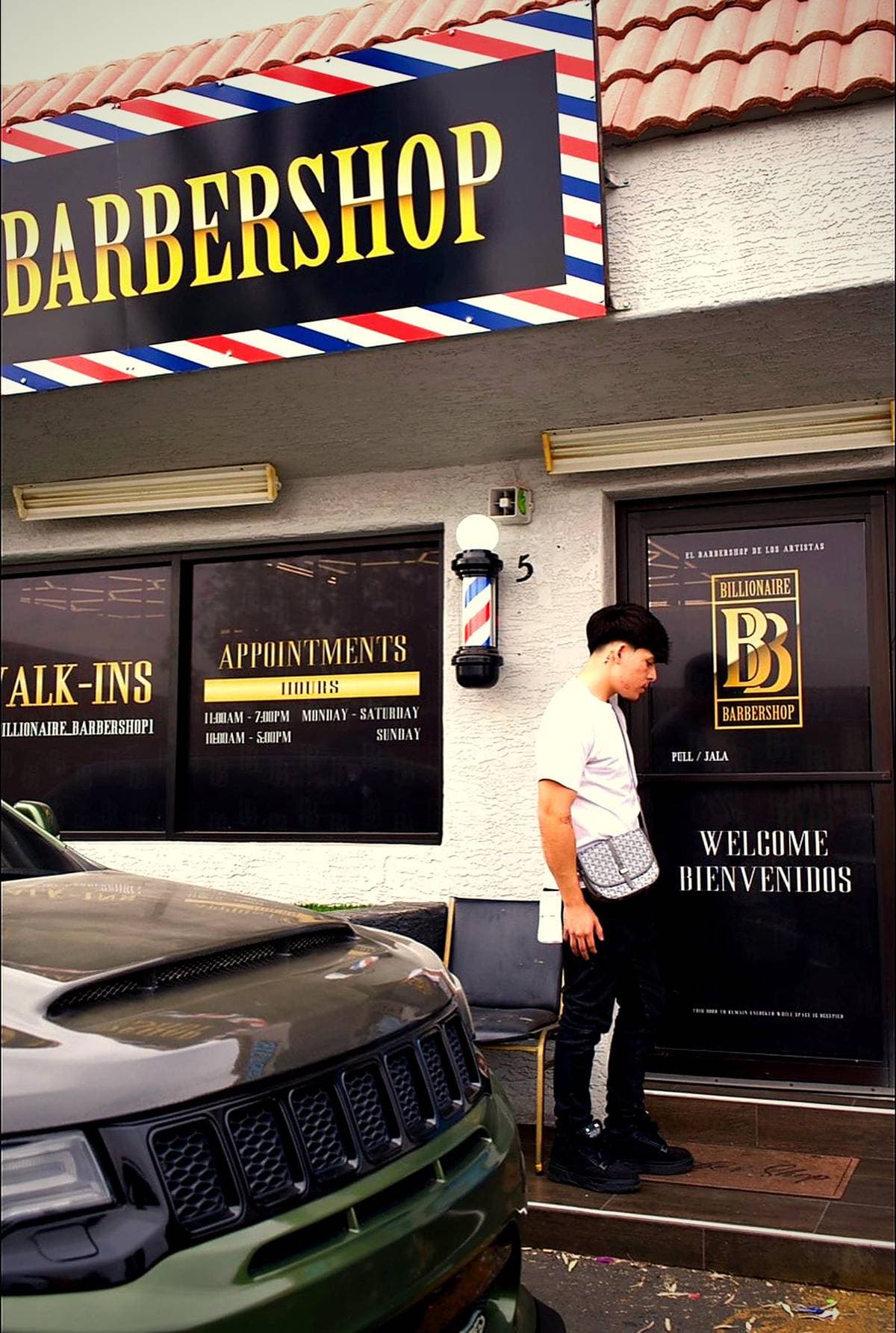 Joel Da Barber at the Billionaire Barbershop entrance